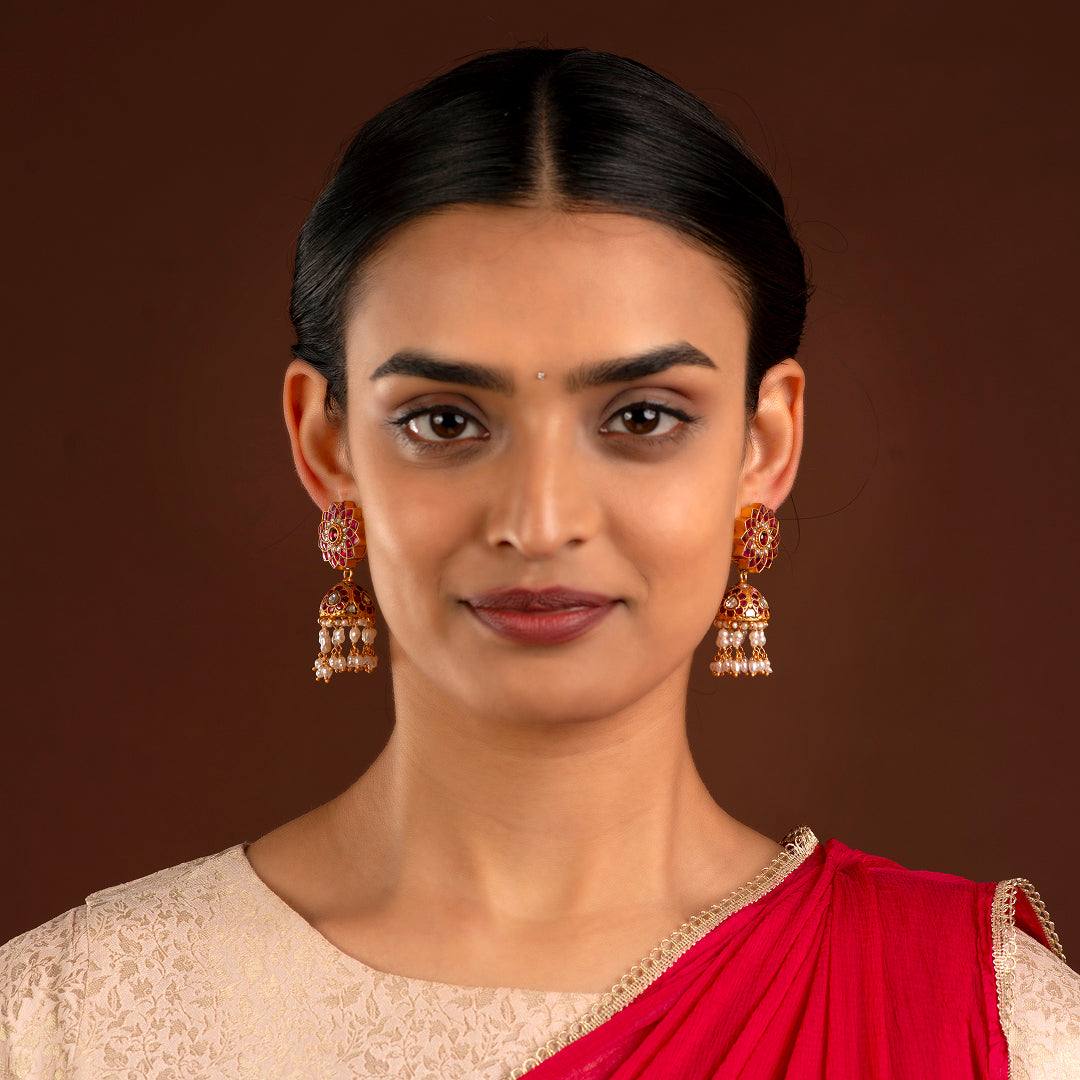 Silver Jhumkas With Floral Pattern by Tavya Jewellery - styled close-up