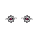 Lotus-bloom toe rings with a red center stone in oxidized Pure 92.5 Silver featuring floral detailing and open bands.