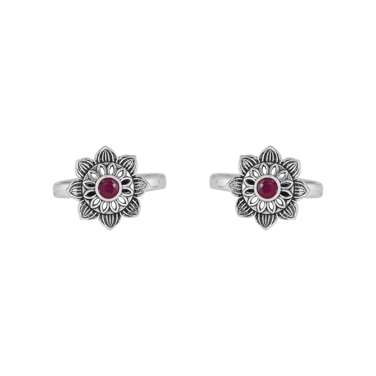 Lotus-bloom toe rings with a red center stone in oxidized Pure 92.5 Silver featuring floral detailing and open bands.