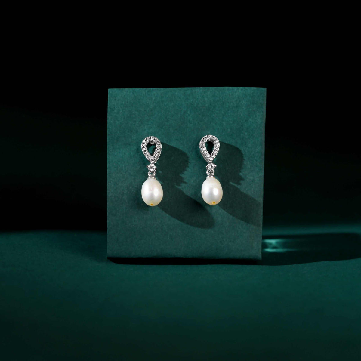 White Pearl Drop Earrings Adorned with Sparkling Stones by Tavya Jewellery - close-up detail