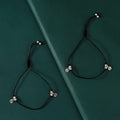 Pure Silver Floral Charms Anklets featuring black thread with oxidized silver floral charms and silver beads on adjustable ties