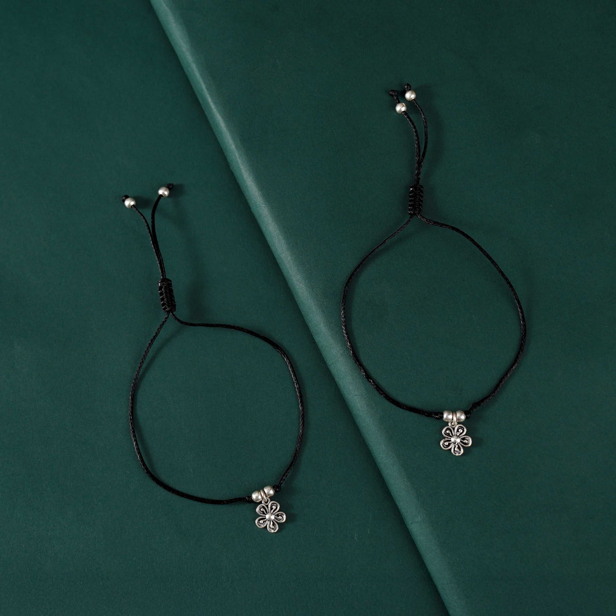 Oxidized Silver Flower Charm Black Thread Anklets by Tavya Jewellery - front view