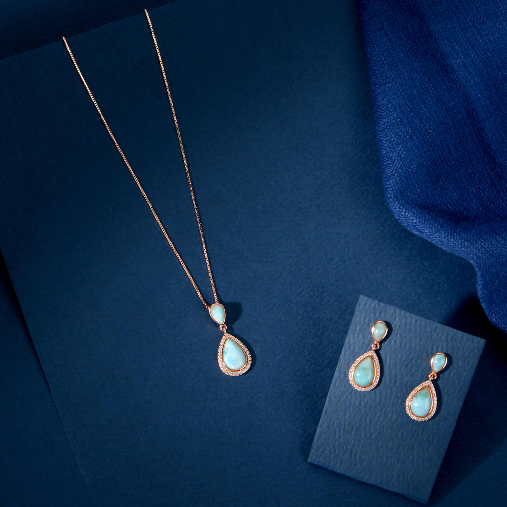 Turquoise Drop Pendant Set featuring rose gold with turquoise-blue teardrop stones framed by sparkling CZ on a delicate chain and matching earrings.