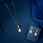 Turquoise Drop Pendant Set featuring rose gold with turquoise-blue teardrop stones framed by sparkling CZ on a delicate chain and matching earrings.