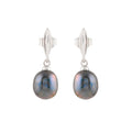 Silver Earrings with sleek silver setting and hanging round black pearls exhibiting subtle iridescent hues and smooth texture