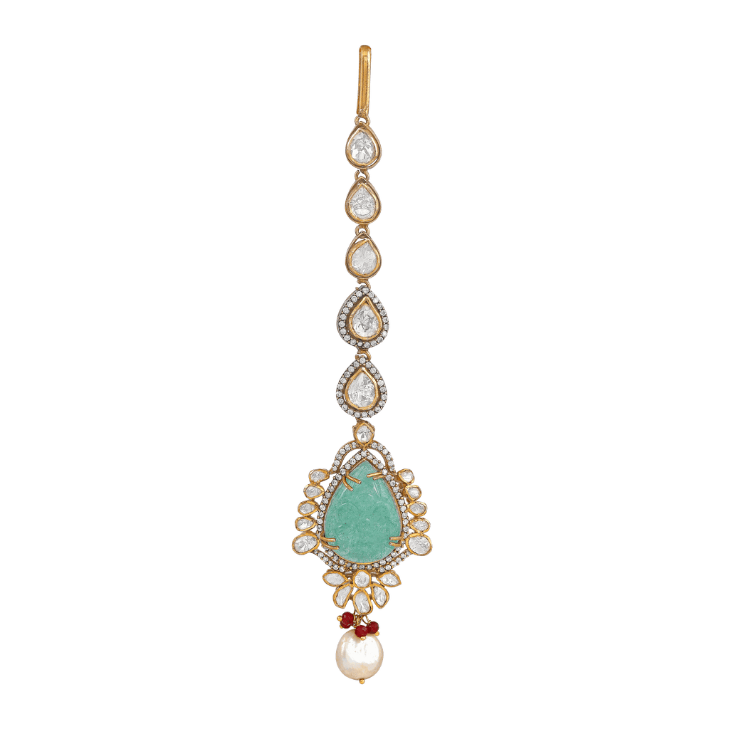 Silver Polki Maang Tikka featuring a pear-cut green stone, white polki diamonds, red bead accents, and a dangling pearl bead.