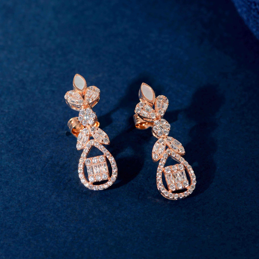Rose Gold Baguette drop earrings with floral inspired design featuring baguette, marquise, and round clear stones in rose gold tone
