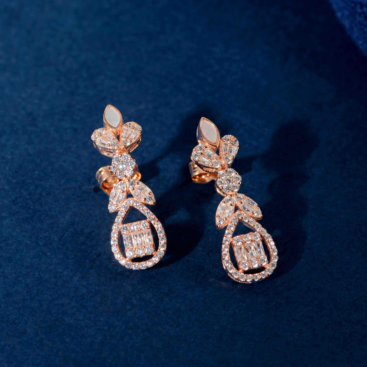 Rose Gold Baguette drop earrings with floral inspired design featuring baguette, marquise, and round clear stones in rose gold tone