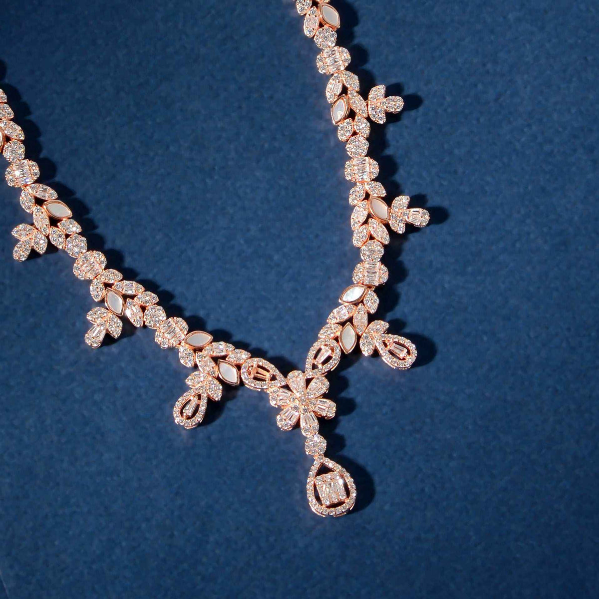Rose Gold Baguette floral necklace with intricate clusters of baguette and round stones and a hanging teardrop pendant