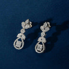 Silver Baguette Floral Set featuring silver drop earrings with baguette, marquise, and round clear stones in floral clusters