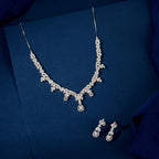 Silver Baguette Floral Set featuring a silver necklace and matching drop earrings with clear baguette, marquise, and round stones in floral patterns