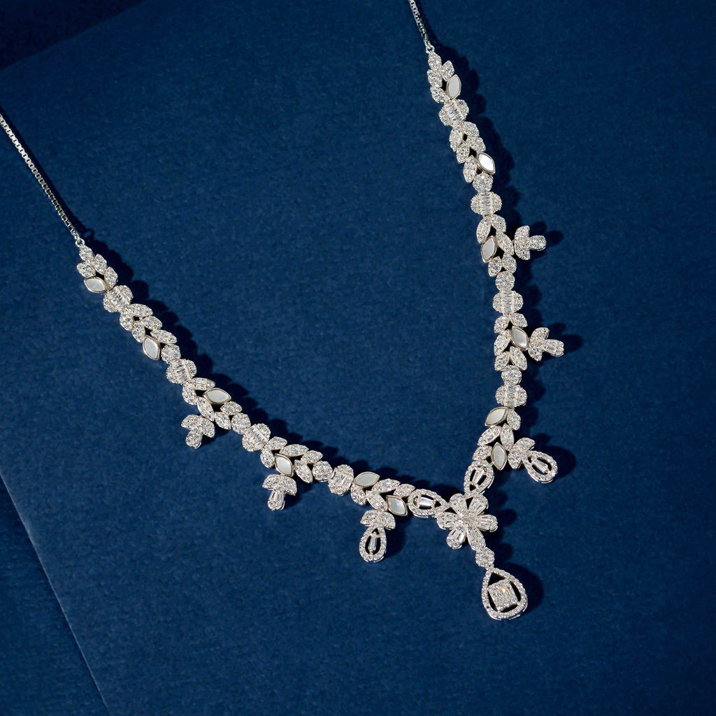 Silver Baguette Floral Set featuring a silver necklace with baguette, marquise, and round CZ stones in floral clusters and a teardrop pendant